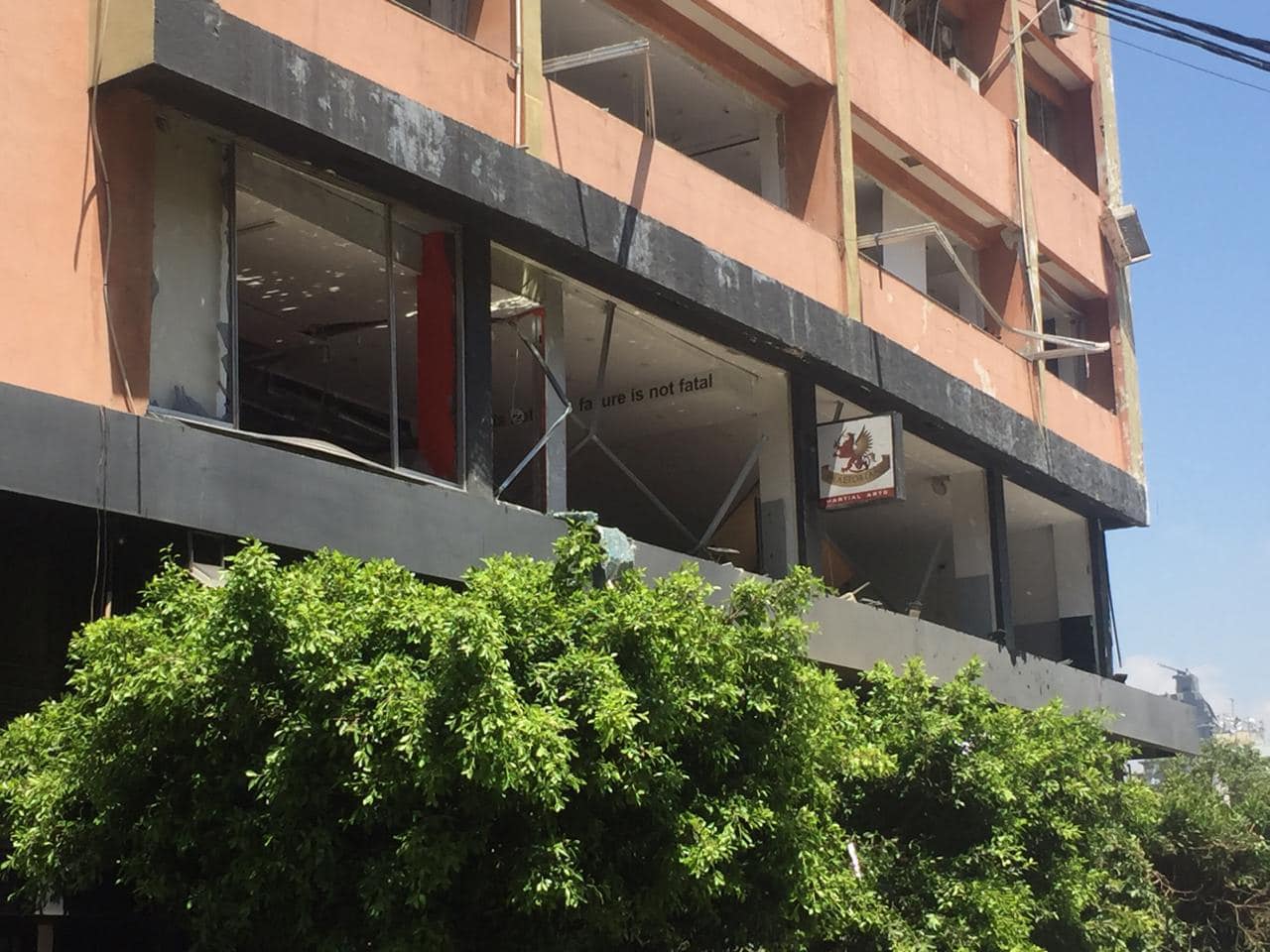 The academy's damaged building facade with the Praetorians sign still hanging